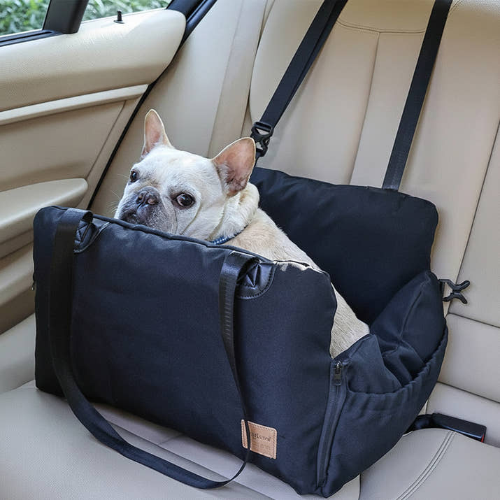 Dog relaxing in Pawsmee waterproof dog car seat cover bed providing comfort and protection during car rides